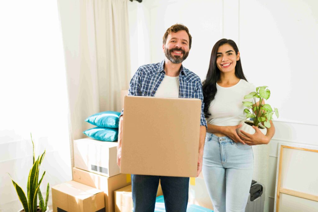 A happy couple packing their belongings and Houseplants for their move 