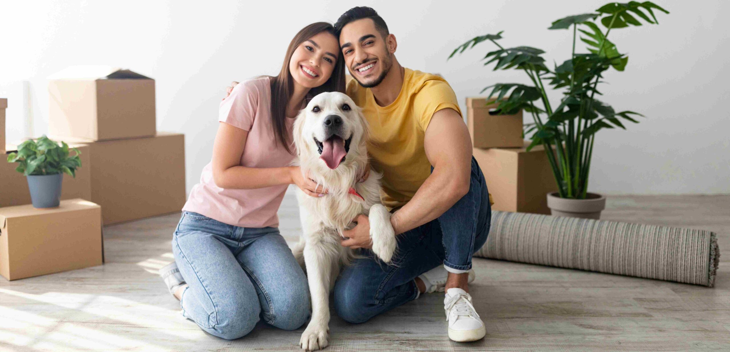 A couple with their dog getting ready for their move